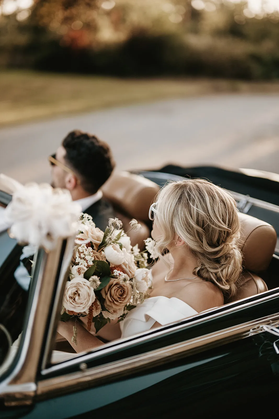 Bride and groom golden hour kiss by vintage car · fashion-editorial wedding photography